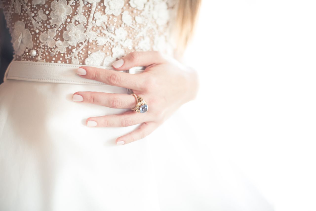 A bride proudly shows off her marvelous engagement ring