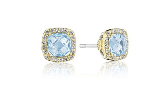 a yellow gold pair of stud earrings featuring halo set blue topaz gems