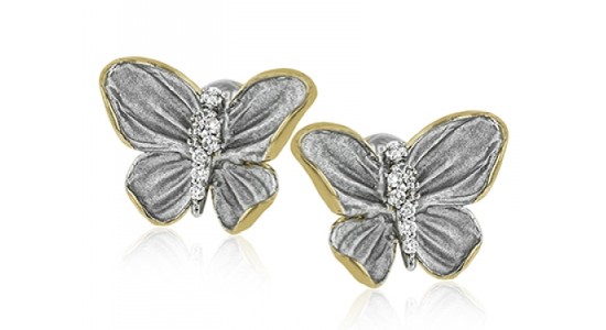 a pair of mixed metal stud earrings shaped like butterflies with diamond details