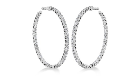a pair of large, white gold hoop earrings dotted with diamonds all the way around
