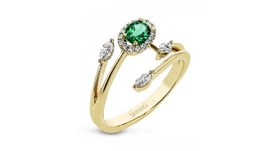 a yellow gold fashion ring featuring an oval cut emerald and diamond accents
