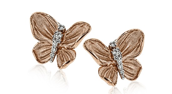 a pair of mixed metal butterfly stud earrings