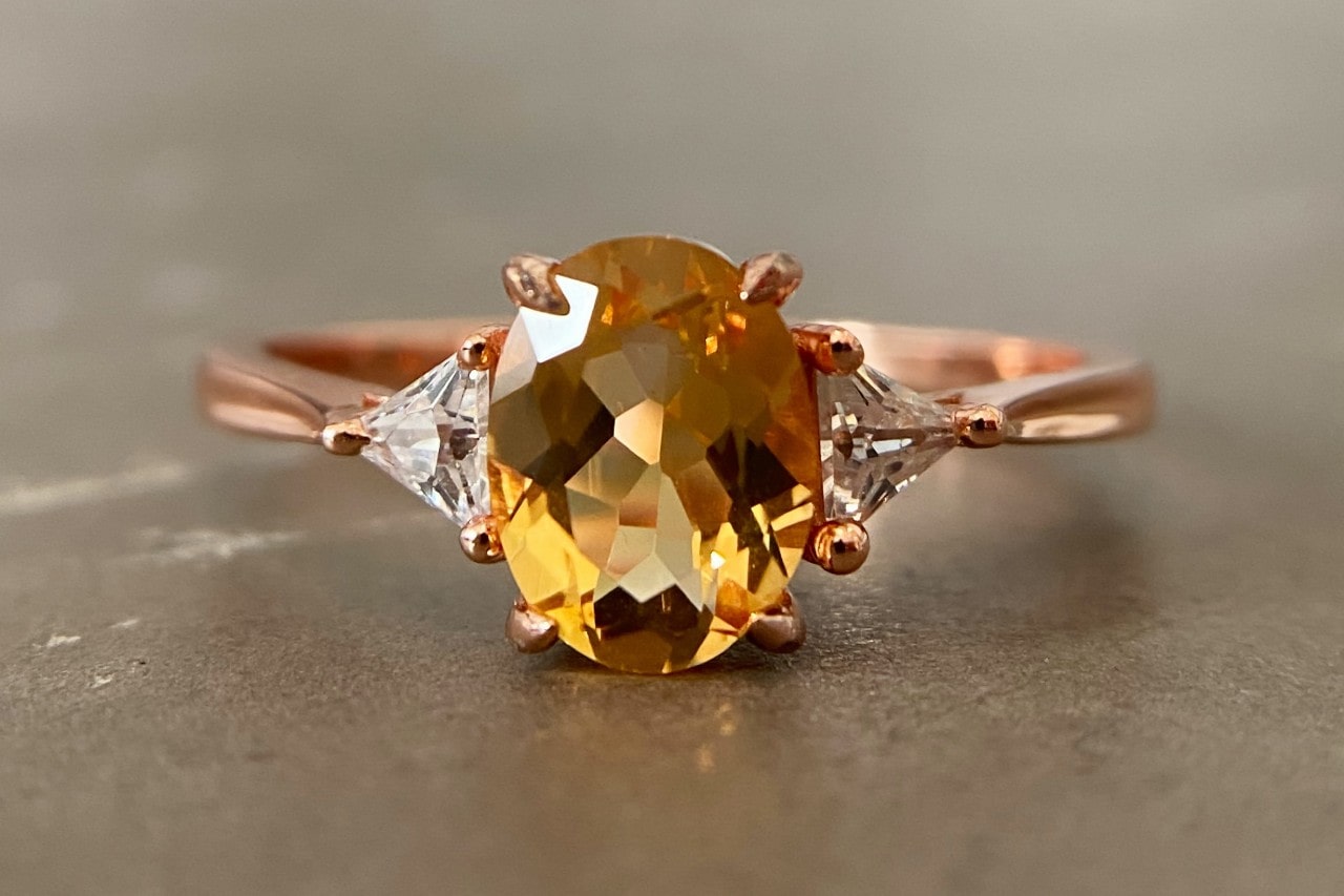 a rose gold fashion ring featuring an oval cut citrine and diamonds