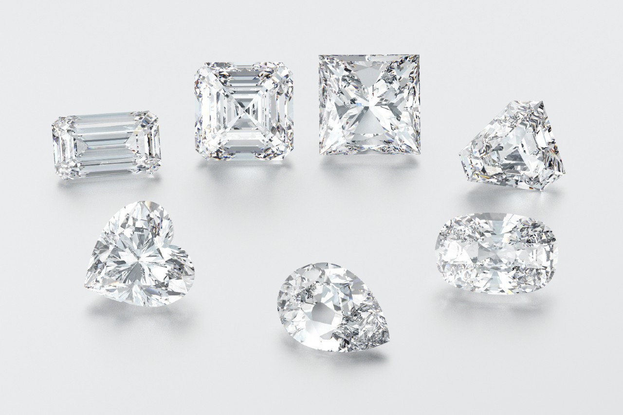 Several diamonds, each in a different cut. From the top-right circling clockwise: emerald, cushion, princess, trilliant, oval, pear, and heart