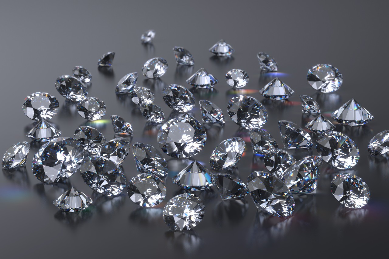 Plethora of diamonds sitting on a shiny surface