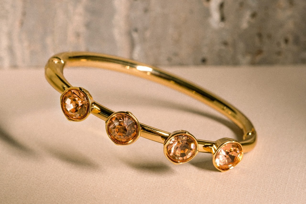 a yellow gold fashion ring featuring four round cut citrine gems