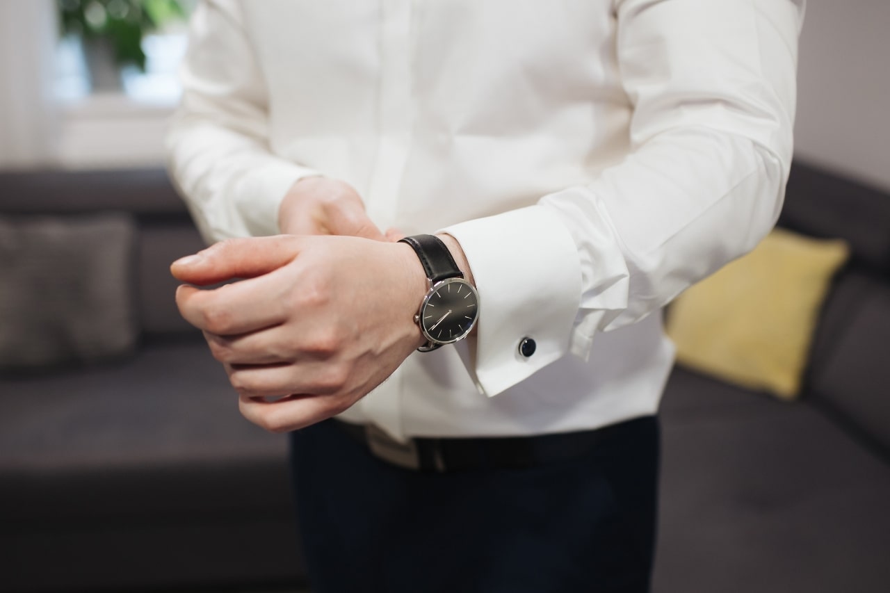 man in white button up with white watch